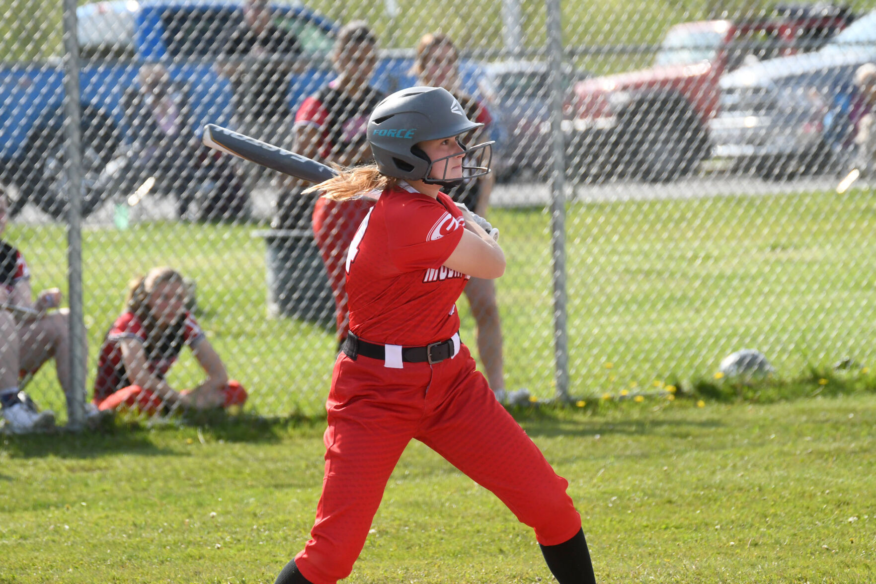 softball player swings